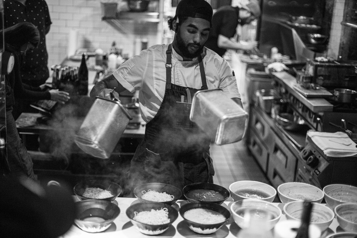 Chef Bill Sanders plating dishes during a busy dinner service